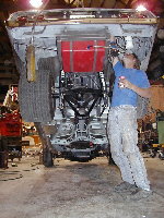 Jimmy checking out something with the car on the shop's 3 ton overhead hoist.