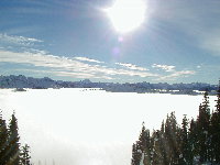 Above the clouds and in the sunshine, looking down at the fog-encased backside of Steven's Pass