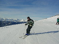 Tim skiing groomers in the sunshine